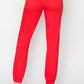 High-waisted red jogger jeans showcasing a flattering fit with a relaxed silhouette and elastic cuffs.