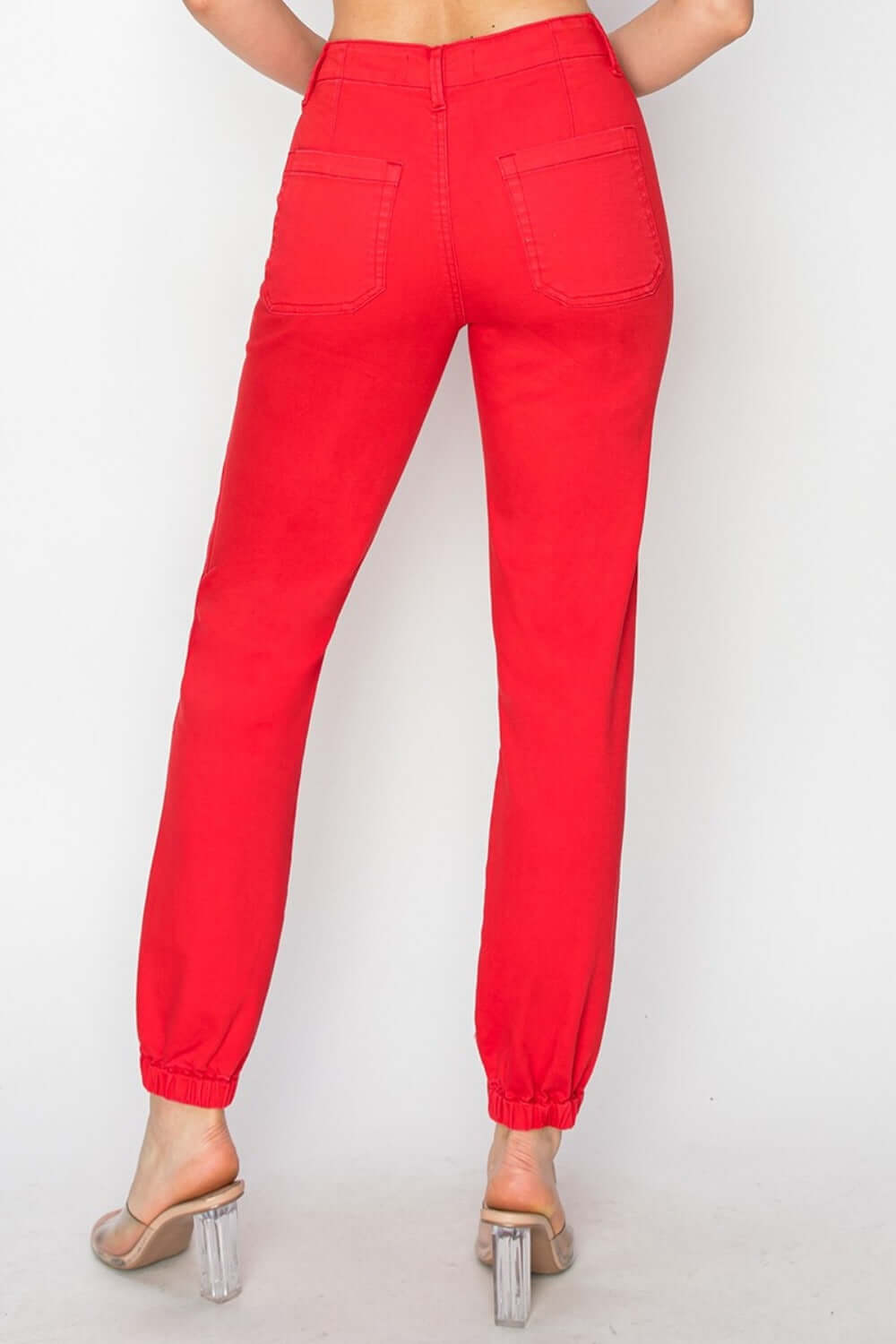 High-waisted red jogger jeans showcasing a flattering fit with a relaxed silhouette and elastic cuffs.