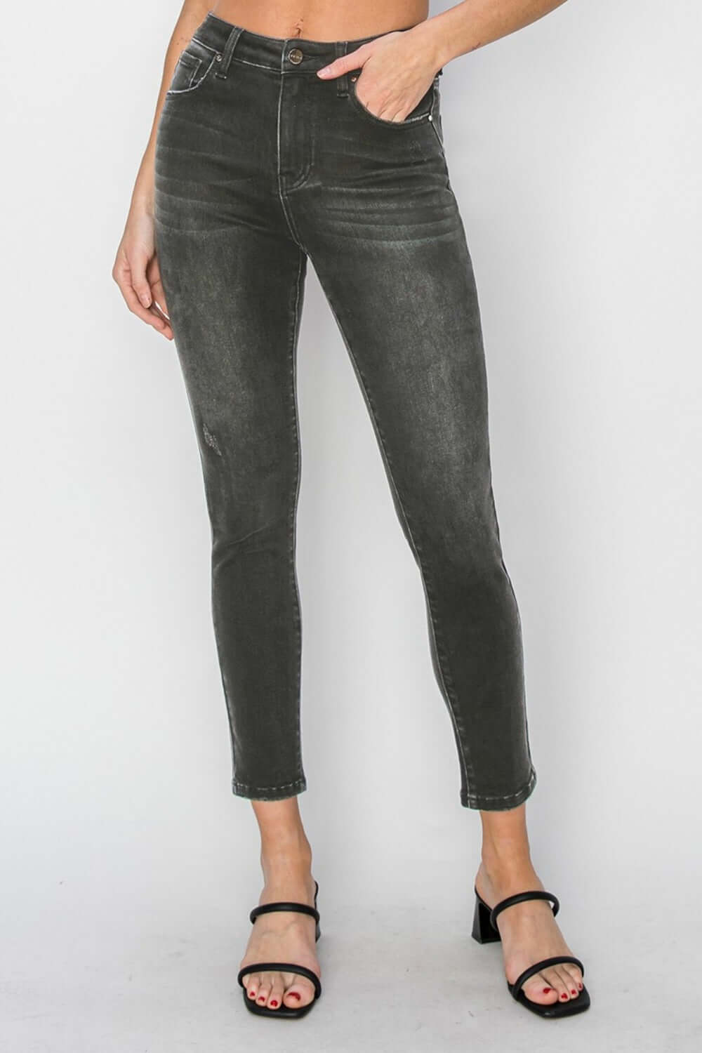 High Rise Ankle Skinny Jeans in dark wash, showcasing stylish and comfortable high-waisted design that elongates legs and enhances silhouette.