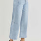 Risen full size high rise seamed detail wide leg crop jeans in light blue denim with a chic ankle-length cut, styled with white heels.