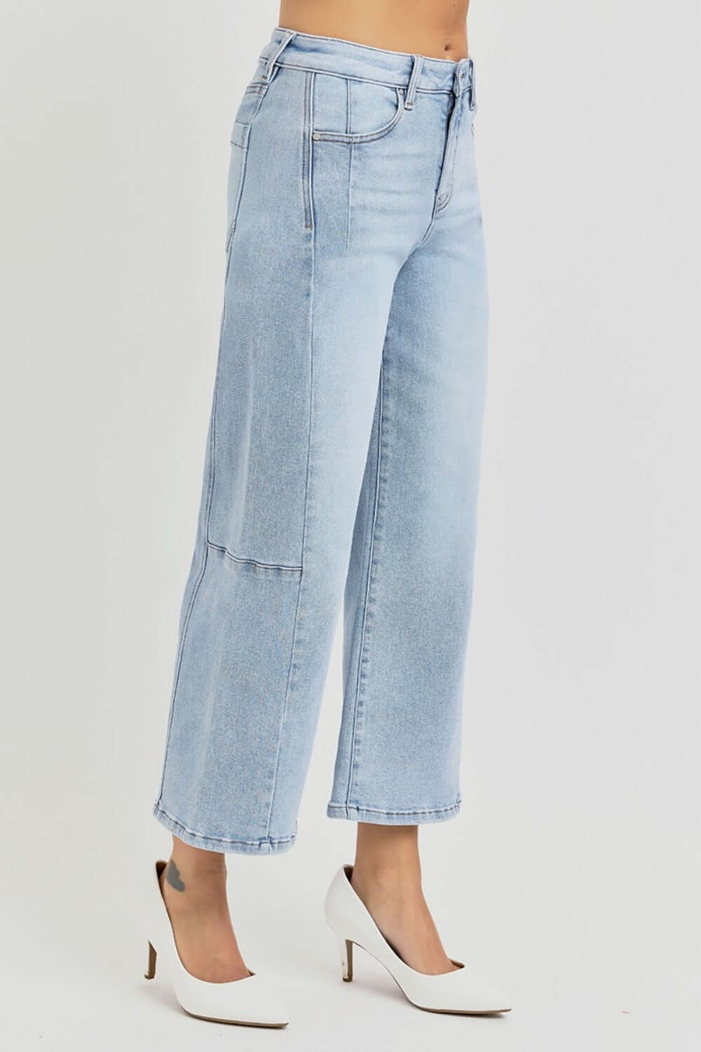 Risen full size high rise seamed detail wide leg crop jeans in light blue denim with a chic ankle-length cut, styled with white heels.