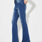 Woman wearing mid-rise waist bootcut jeans with pockets, button closure, and no stretch. Made of 85% cotton and 15% polyester.