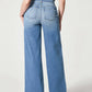 Woman wearing chic wide leg long jeans with moderate stretch, back view showing solid pattern and basic style, ideal for casual wear.