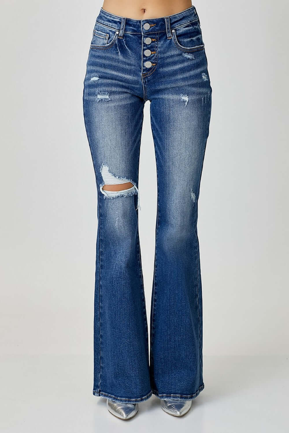 Distressed button-fly flare jeans with pockets and slight stretch by Risen Jeans, stylishly worn with a trendy flared design.