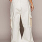 Back view of white crochet patch pants with elastic waistband and relaxed fit, perfect for trendy, casual outfits.