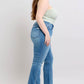 Model showcasing Judy Blue high waist tummy control vintage wash side slit slim boot jeans in a stylish pose.