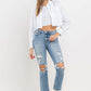 Woman wearing Lovervet Full Size High Rise Slim Straight Jeans with a white cropped jacket and sneakers