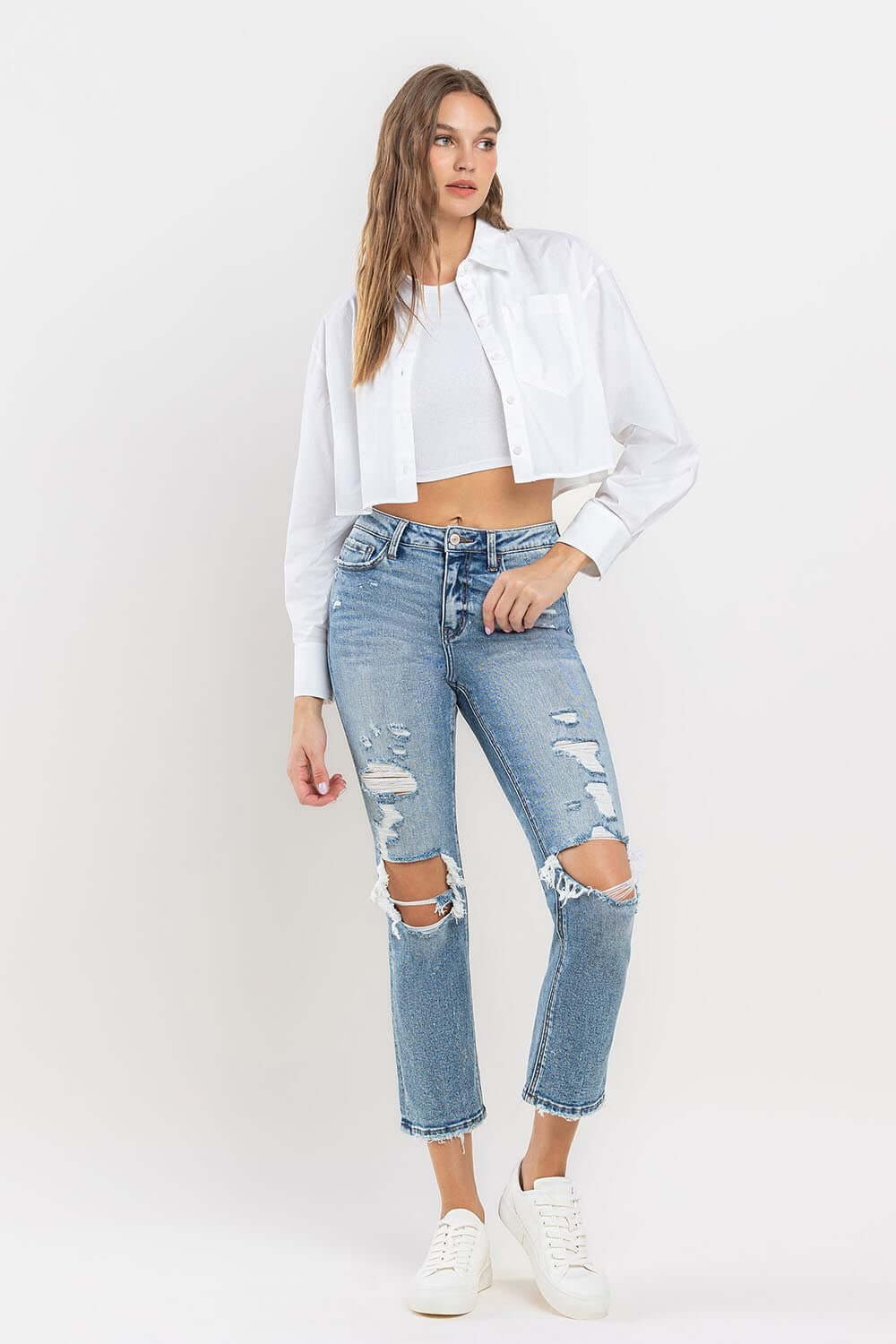 Woman wearing Lovervet Full Size High Rise Slim Straight Jeans with a white cropped jacket and sneakers