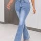 Woman wearing highly stretchy bootcut jeans with pockets, buttoned front detail, and a light blue wash. Suitable for casual outfits.