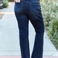 Woman wearing slim bootcut jeans with back pocket detail, perfect modern style and comfort for any occasion