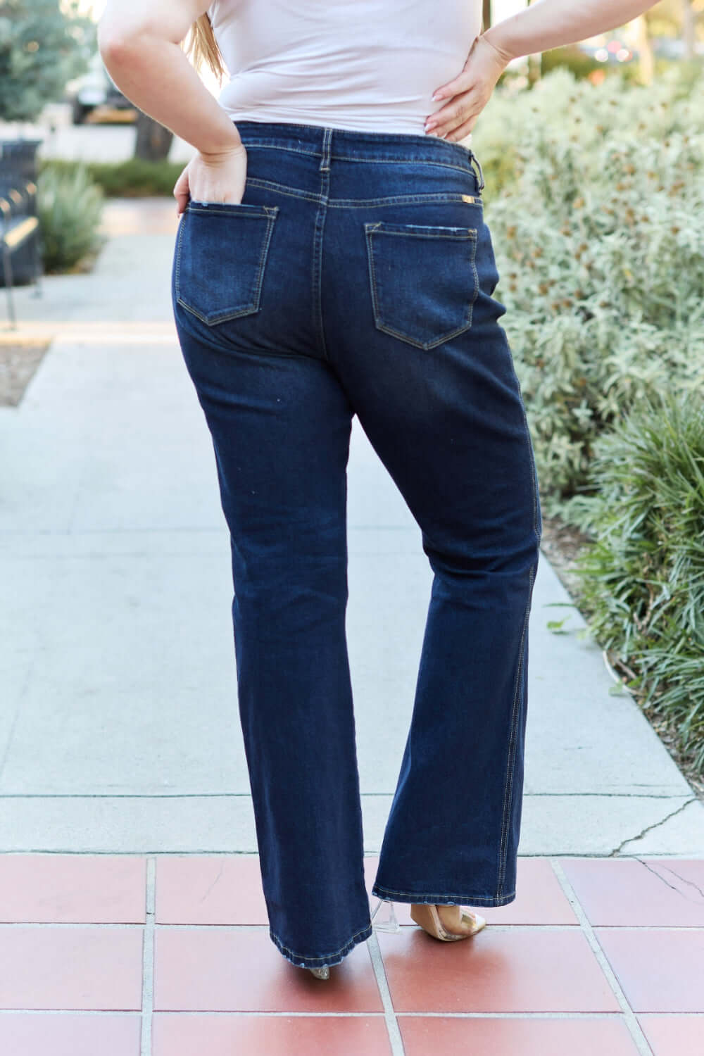 Woman wearing slim bootcut jeans with back pocket detail, perfect modern style and comfort for any occasion