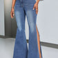 Woman wearing slit flare jeans with pockets, featuring a button closure and highly stretchy fabric for comfort and style.