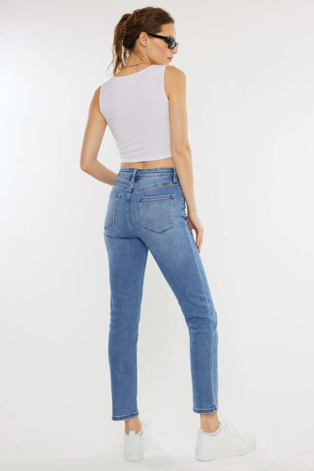 Back view of woman wearing Cat's Whiskers High Waist Jeans with vintage detailing, showcasing a flattering silhouette.