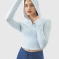 Model wearing light blue Millennia Zip Up Hooded Long Sleeve Active Outerwear, showcasing its stylish and functional design.