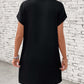 Back view of Letter Graphic Short Sleeve Mini Tee Dress in black, showing slightly stretchy fabric and basic style, worn by a model.