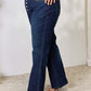 Woman wearing Judy Blue button-fly straight jeans with high waist and slight stretch for a flattering fit.