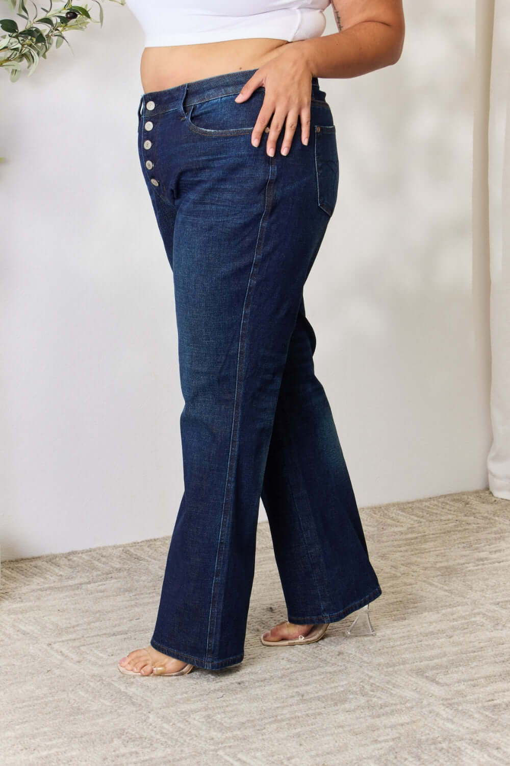 Woman wearing Judy Blue button-fly straight jeans with high waist and slight stretch for a flattering fit.