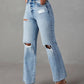 Bella Road distressed straight leg jeans with pockets shown on model, featuring ripped knees and button details, made of cotton and polyester.