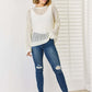 Woman wearing openwork ribbed trim long sleeve knit top with jeans, showcasing modern and trendy look