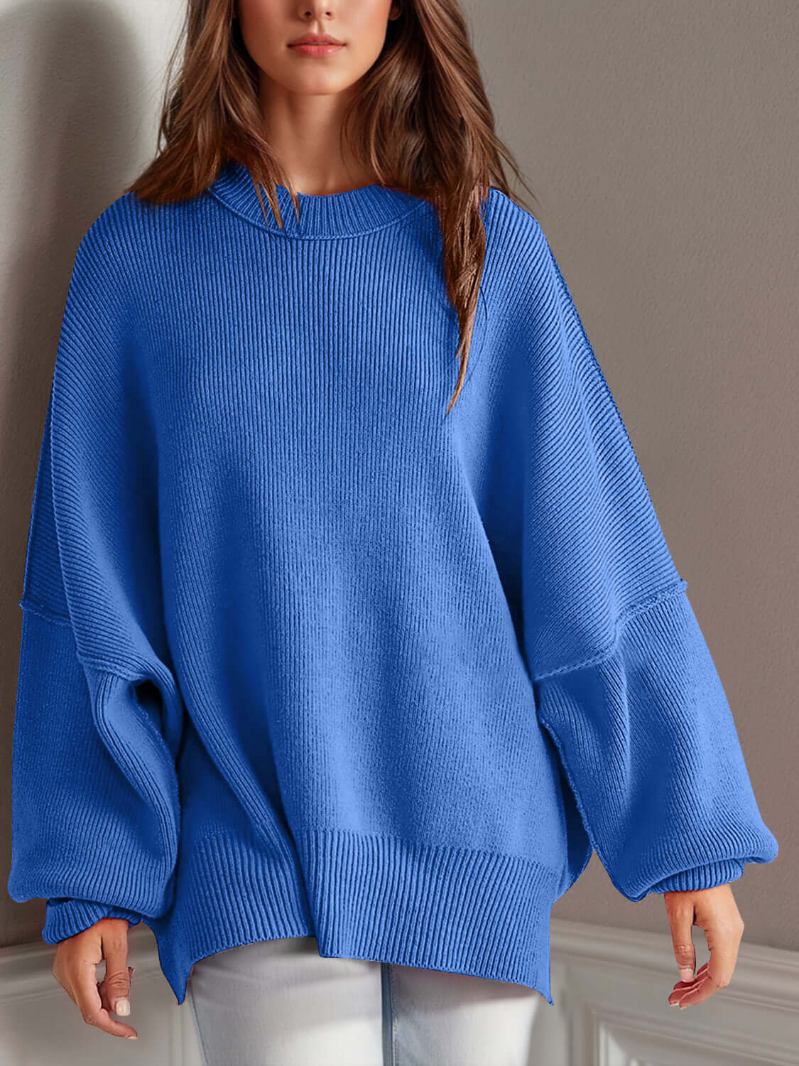 Woman wearing blue Double Take Side Slit Round Neck Long Sleeve Sweater with moderate stretch and classic round neck.