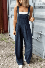 Stylish woman wearing Bella Road plaid wide strap wide leg overalls, perfect for a trendy and comfortable look.