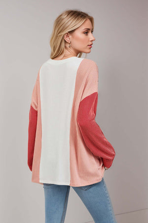 Woman wearing Double Take Texture Contrast Round Neck Long Sleeve T-Shirt in pink and red, perfect for trendy layering styles.