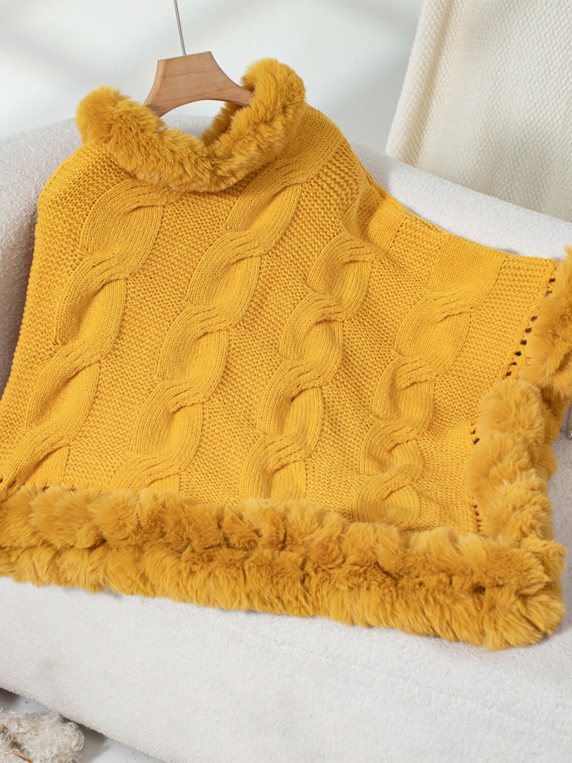 Cozy yellow Bella Road Fuzzy Hem Cable-Knit Poncho with soft fuzzy hem, perfect for chilly days in stylish comfort.