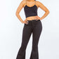 Woman wearing high waist pull-on flare jeans and black tank top, showcasing fashionable flare leg design for a chic look.