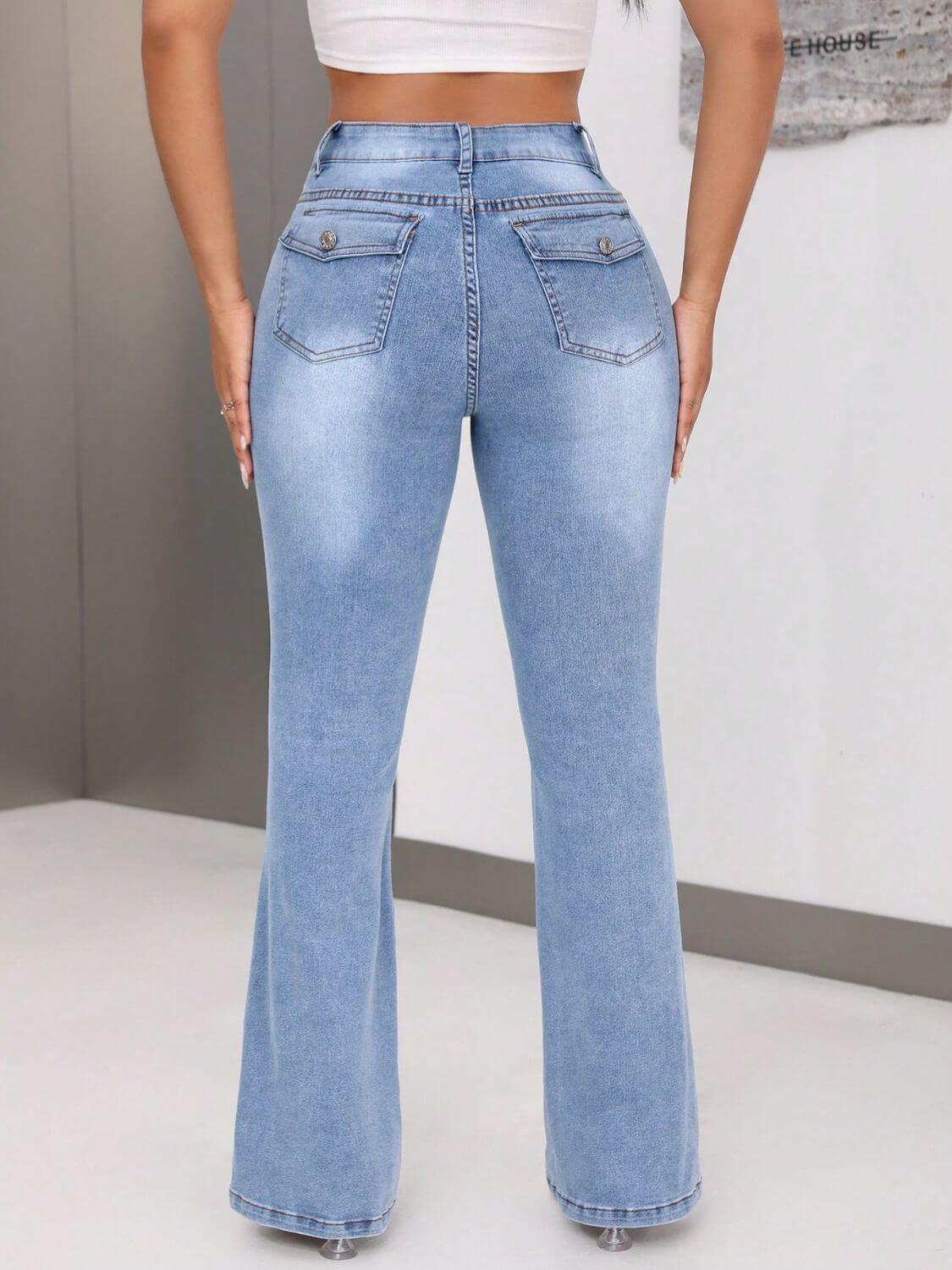 Woman wearing light blue bootcut jeans with back pockets, showcasing slim fit and high stretch material.