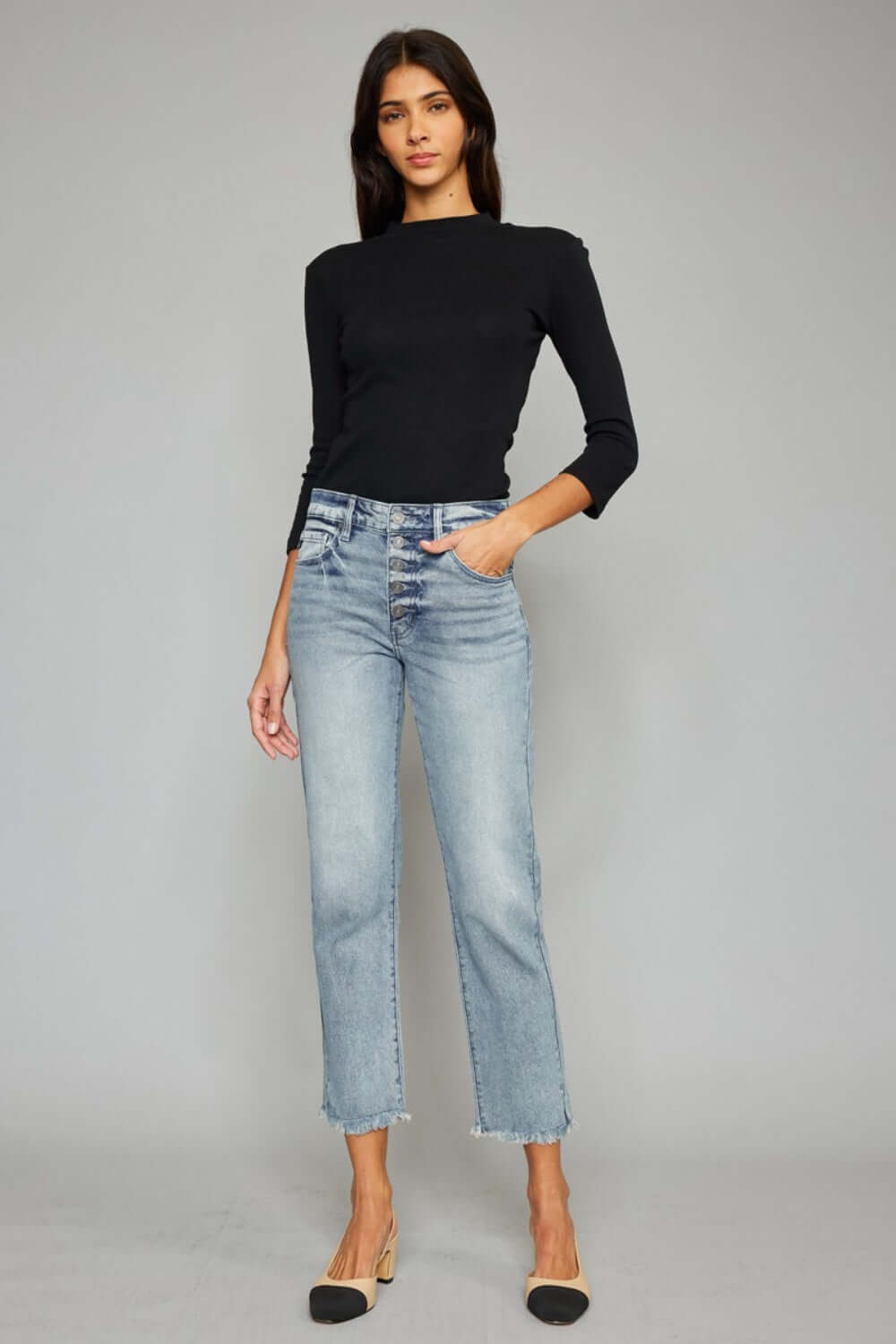 Woman wearing High Waist Button Fly Raw Hem Cropped Straight Jeans, stylish vintage-inspired look with a flattering high waist and edgy raw hem detailing.