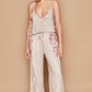 Woman wearing Adjustable Strap Lace Trim Cami with delicate detailing and floral pants, ideal for layering or warm weather.