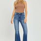 Woman wearing High Rise Front Slit Frayed Hem Flare Jeans by Risen, showcasing trendy high-rise design, front slit, frayed hem, and flared silhouette.