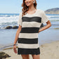 Woman wearing Bella Road Swim Openwork Round Neck Cover-Up with black and white stripes on a beach.