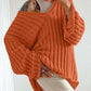 Woman wearing Bella Road orange V-neck long sleeve sweater with cozy distressed design, perfect for trendy fall outfits.