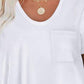 Woman wearing Bella Road round neck long sleeve t-shirt with pocket detail and gold necklace.