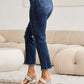 Tummy Control Distressed High Waist Raw Hem RFM Jeans in dark denim modeled with white heels, side view.