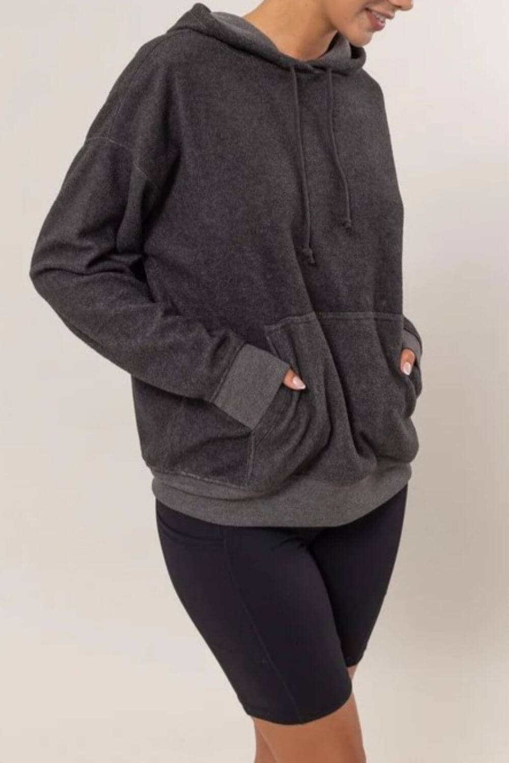 Cozy black brushed long sleeve hoodie with kangaroo pocket, perfect for casual outings and chilly days.