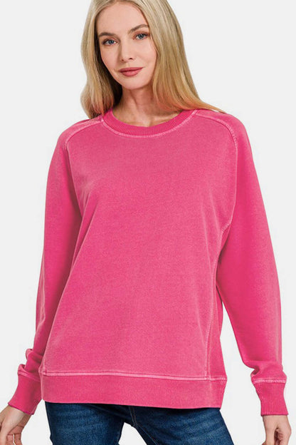 Stylish woman in a pink pigment dyed French terry sweatshirt, showcasing vintage color and relaxed fit for casual wear.