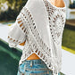 Trendy white crochet cover-up featuring fringe details, perfect for summer outings or beach days.