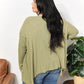 Oversized super soft ribbed layering top with sharkbite hem in olive green, shown from the back, perfect for cozy elegance.