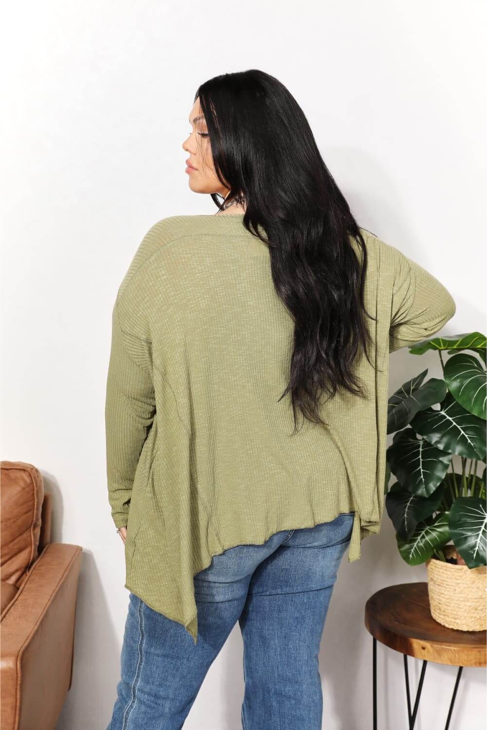 Oversized super soft ribbed layering top with sharkbite hem in olive green, shown from the back, perfect for cozy elegance.