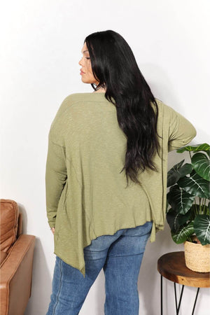 Oversized super soft ribbed layering top with sharkbite hem in olive green, shown from the back, perfect for cozy elegance.