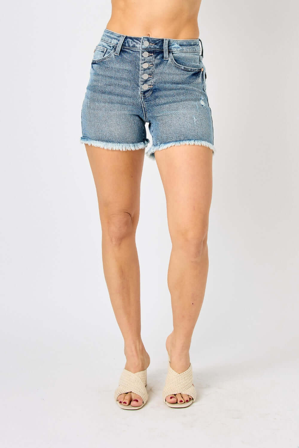 Button Fly Raw Hem Denim Shorts from Judy Blue Jeans, trendy and stylish casual wear for summer days and nights, featuring a unique button fly closure