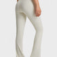 Model showcases Millennia Elastic Waist Flare Yoga Pants in cream, perfect for yoga and workouts with ultimate comfort and style.