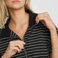 Stylish woman in striped half zip short sleeve sweatshirt, perfect for spring and summer sports and leisure activities.