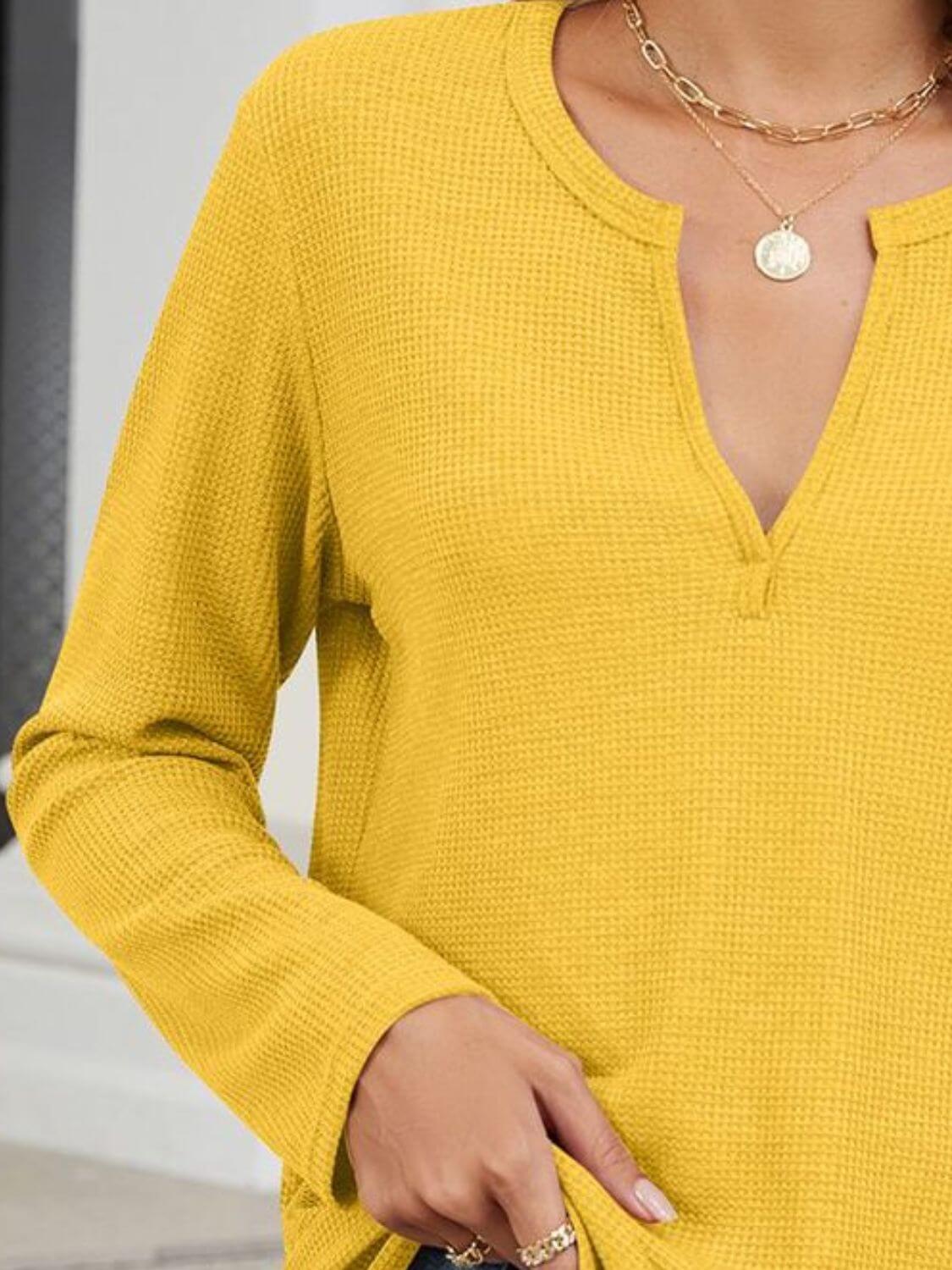 Woman wearing Bella Road Waffle-Knit Notched Long Sleeve T-Shirt in yellow, showing textured fabric and notched neckline.