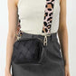 Stylish woman wearing the Zenana Cassette Woven Crossbody Bag with a trendy leopard strap and chic outfit.