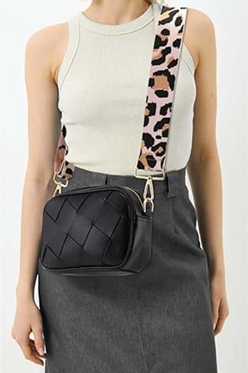 Stylish woman wearing the Zenana Cassette Woven Crossbody Bag with a trendy leopard strap and chic outfit.