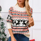 Woman wearing Angel Wings Reindeer Round Neck Long Sleeve Sweater, festive design, holding a cup, standing by holiday decor.