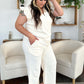 Woman wearing a Texture Ruffle Short Sleeve Top and Drawstring Wide Leg Pants Set in a light-colored room with modern decor.